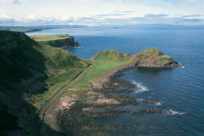 Giant's Causeway and Whisky Distillery tasting tour from Belfast - Dunluce Castle ruins: a 5-minute photo stop that can still work
