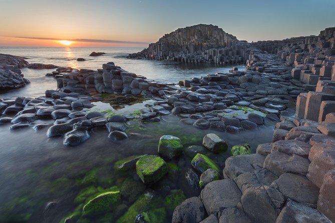 Basalt columns at the Giant’s Causeway with the sun low over the Atlantic